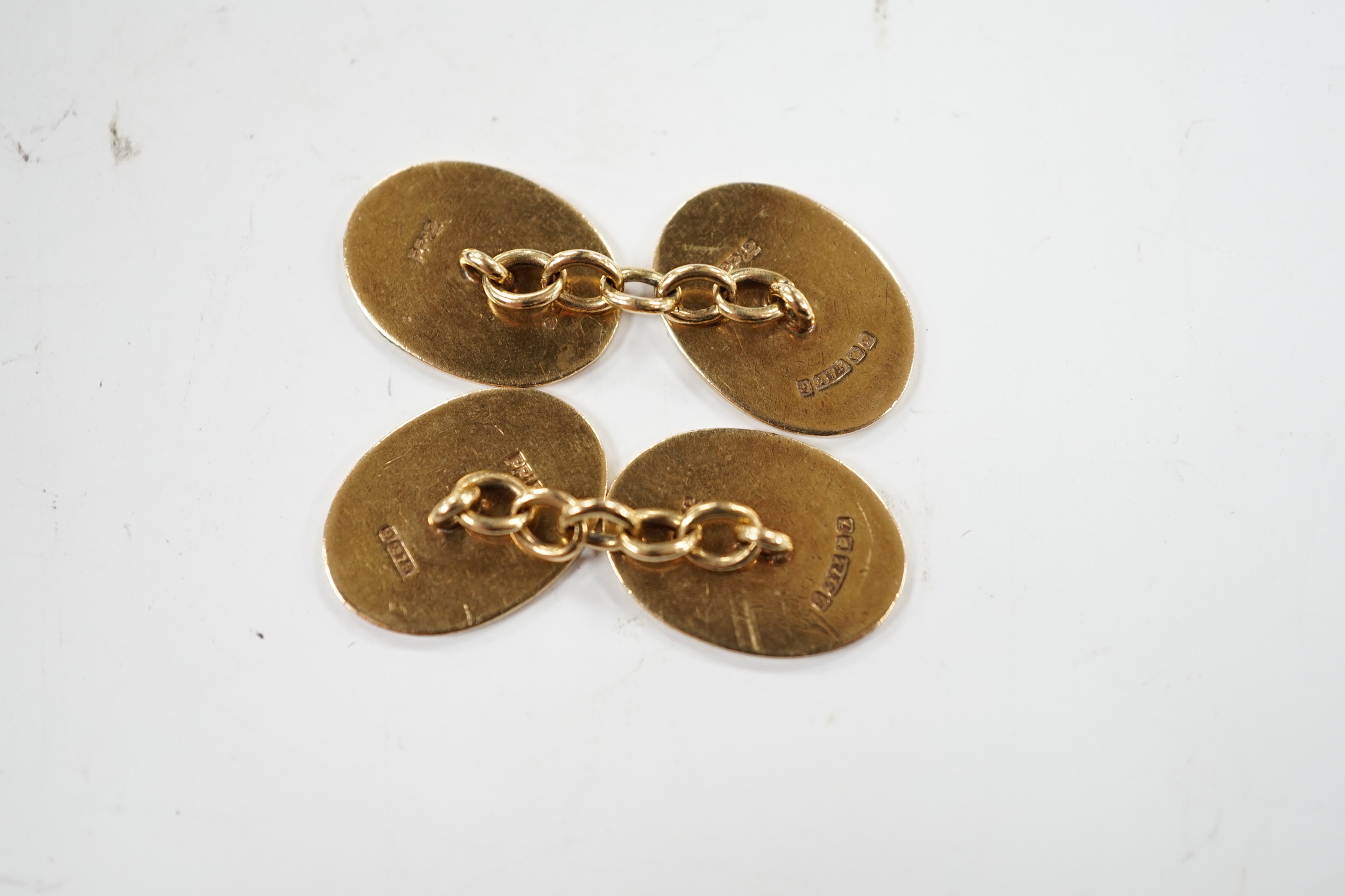 A pair of early 1960's 9ct gold oval cufflinks, with engraved crest and monogram, 10.3 grams.